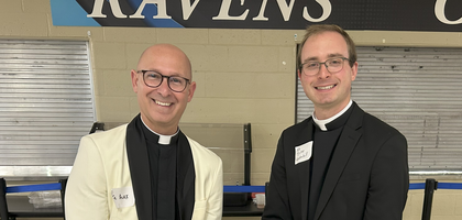 Father Alex Zenthoefer (left), rector of St. Benedict Cathedral and chaplain of St. Benedict Cathedral Council 7544 in Evansville, Ind., and Father Tyler Underhill, parochial vicar and a brother Knight, display a cake during a dinner hosted by the council at St. Benedict Cathedral School. Nearly 300 people attended the event, which celebrated Father Underhill’s recent appointment to the cathedral and Father Zenthoefer’s 20th anniversary of priesthood.