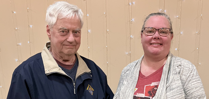 Grand Knight Vaughn Wadelius of Charlebois Council 2704 in The Pas, Manitoba, presents a CA$500 check to Stephanie Johnston, administrative support clerk for the Rural Municipality of Kelsey, to help with food costs for residents evacuated due to wildfires. About 1,000 people were displaced, with more than 200 sheltering in The Pas.