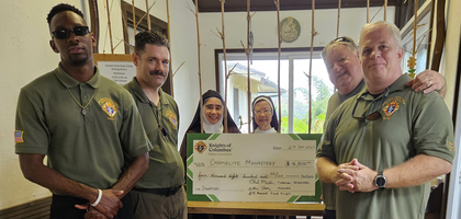 Members of Joint Base Pearl Harbor-Hickam Council 18025 in Mililani, Hawaii, present a check for $4,800 to Discalced Carmelite nuns from the Carmel of the Holy Trinity monastery in Kaneohe. Knights also assist with monthly maintenance and landscaping at the monastery. 