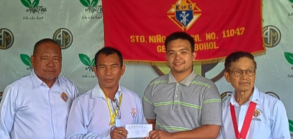 K of C leaders deliver a check for 3,000 PHP (about $50) to Vincent Valendez (second from right), a member of Sto. Niño Council 11047 in Getafe, Visayas, for his father, Eduardo, also a Knight, to help offset the cost of rebuilding his house after a recent fire. The donation came from the emergency response fund of the Bohol Knights of Columbus Fraternal Association, Inc. Presenting the donation are (from left) Grand Knight Diosdado Torreon, District Deputy Bernardo Pojas and District Deputy Teofilo Camacho.