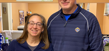 Jeff Koscho, a past grand knight of St. John the Evangelist Council 11171 in Clinton, Md., presents a check for $100 from the Supreme Council to Danielle, a stenographer at Forestville Pregnancy Center in Temple Hills. 