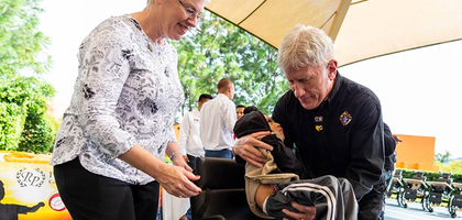 Child being placed in a wheelchair.