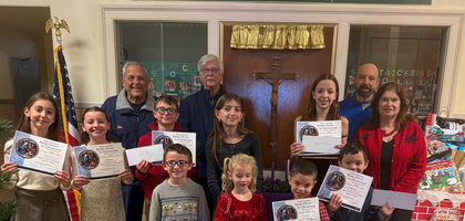 Members of Father John LaFarge, S.J. Council 4012 in Yorktown Heights, N.Y., stand with winners of the council’s Keep Christ in Christmas poster contest at St. Patrick’s School. Winners and runners-up in each grade K-8 received certificates and gift cards. This marked the first time that students from St. Mary’s Academy also participated, and more than 70 entries were received.