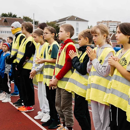 Children competing say a prayer before the games begin