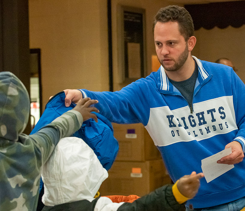 Knight handing out coats.