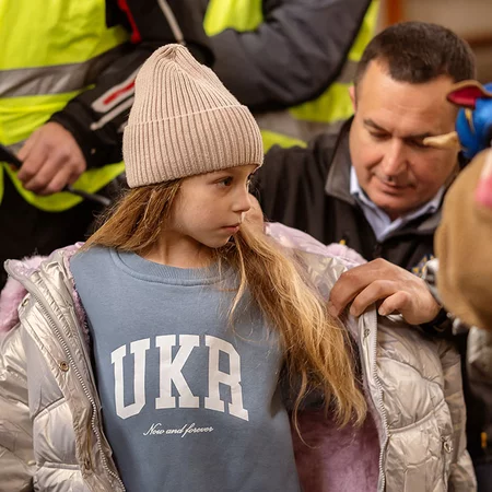 Child receiving a coat.