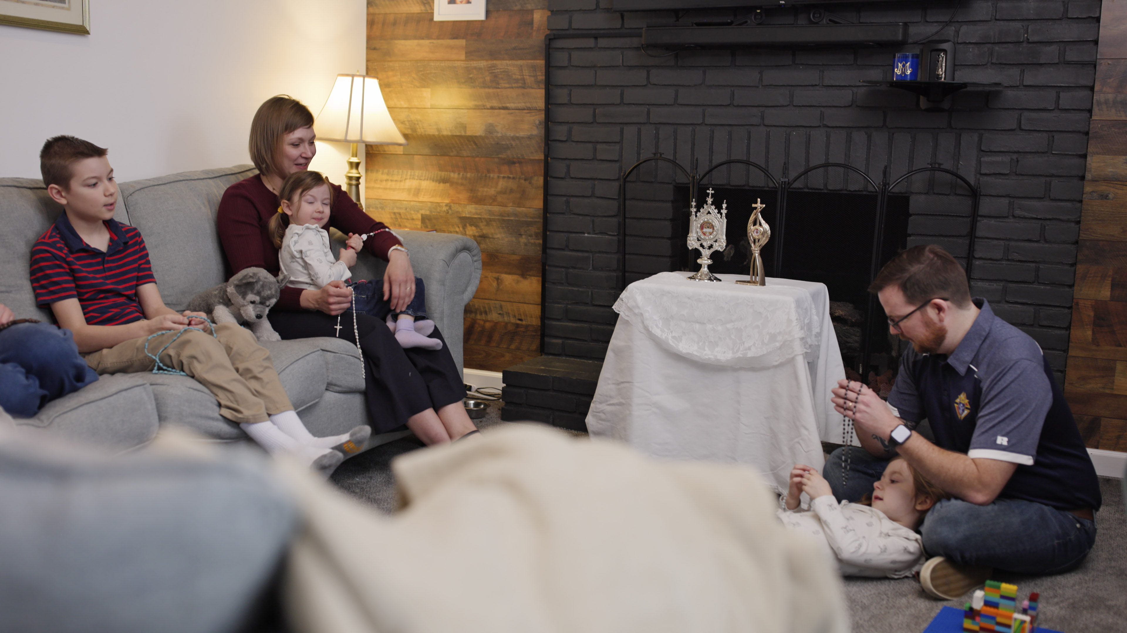 Knights of Columbus Field Agent Christopher Copley prays the rosary with his wife, Destiny, and children at their home in Marion, Ohio.