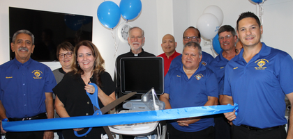 Knights from Holy Family Council 9213 in Kingsburg, Calif., Father Mark Maxon and staff from Care Pregnancy Resource Center in Tulare assemble around a new ultrasound machine purchased with help from Council 9213.