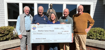 Members of St. John Paul II Council 2344 in Scarborough, Maine, present Cynthia Broyer, director of the Mother Seton House in Fryeburg, with a $4,000 donation.