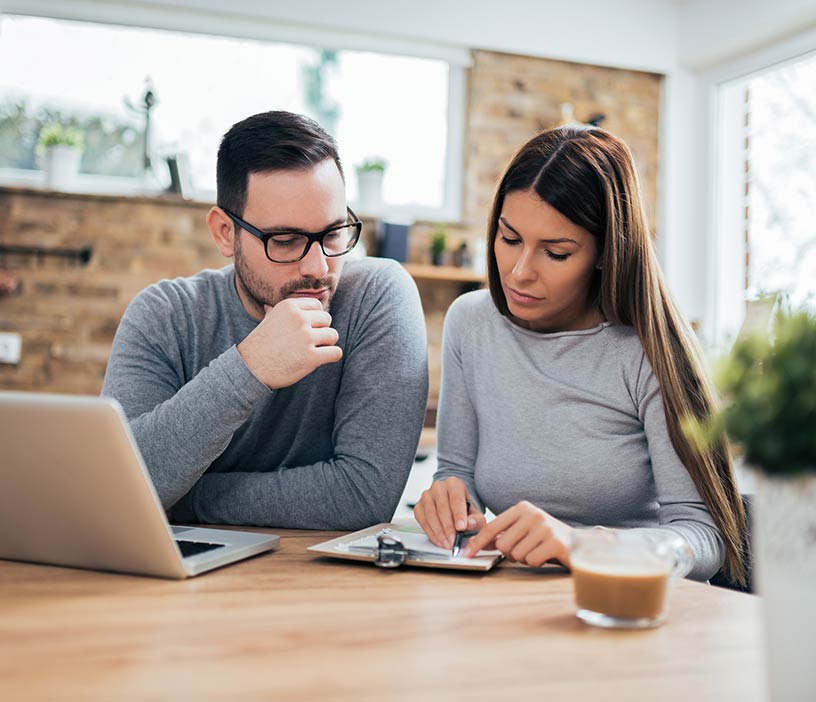 A man and woman reviewing insurance benefits.