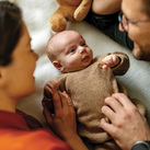 A couple dotes on a baby.