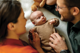 A couple dotes on a baby.