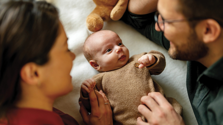 A couple dotes on a baby.