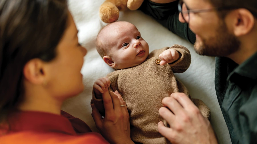 A couple dotes on a baby.