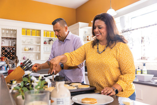 A couple cooks together.