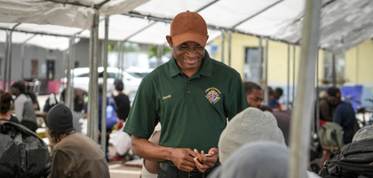 David Green, a member of Msgr. Bishop Council 2112 in Orlando, Fla., greets guests during a free meal at the Christian Service Center.