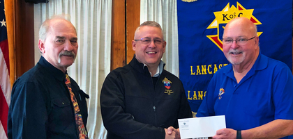 Grand Knight Jim Carr (right) and Past Grand Knight Ed Zalewski (left) of Lancaster (Pa.) Council 867 presents a check for $5,500 to Bill Newbrough (center), donor stewardship coordinator for the U.S. Archdiocese for the Military Services, to support the archdiocese’s ministry. 