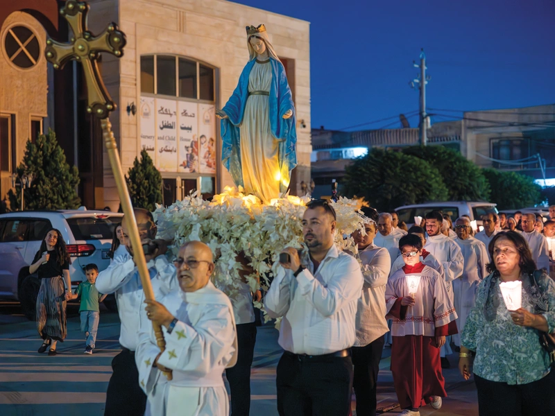 A statue of Mary is carried in procession through the streets of Erbil, Iraq.