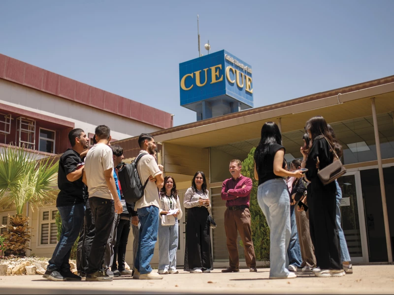 Alex McKenna shares a laugh with students on the campus of the Catholic University in Erbil, the only Catholic university in Iraq.