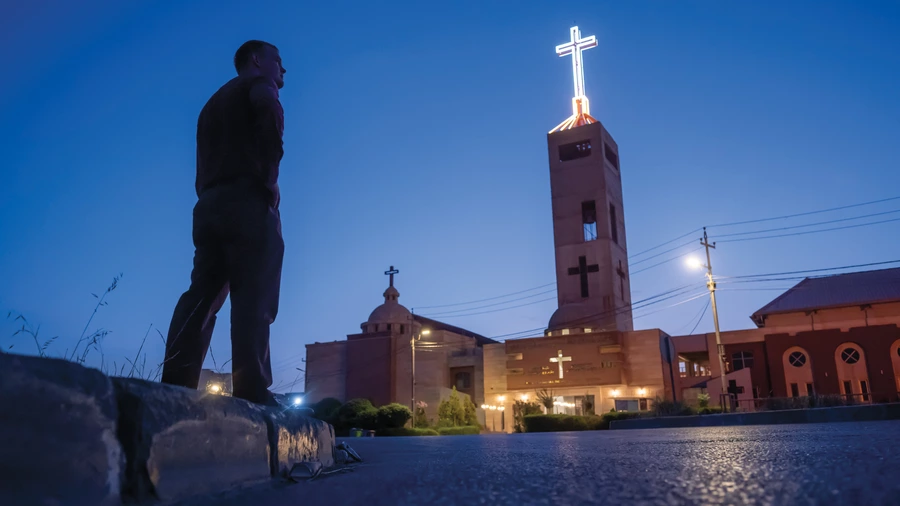 Alex McKenna stands outside Sts. Peter and Paul the Apostles Church in Erbil, Iraq