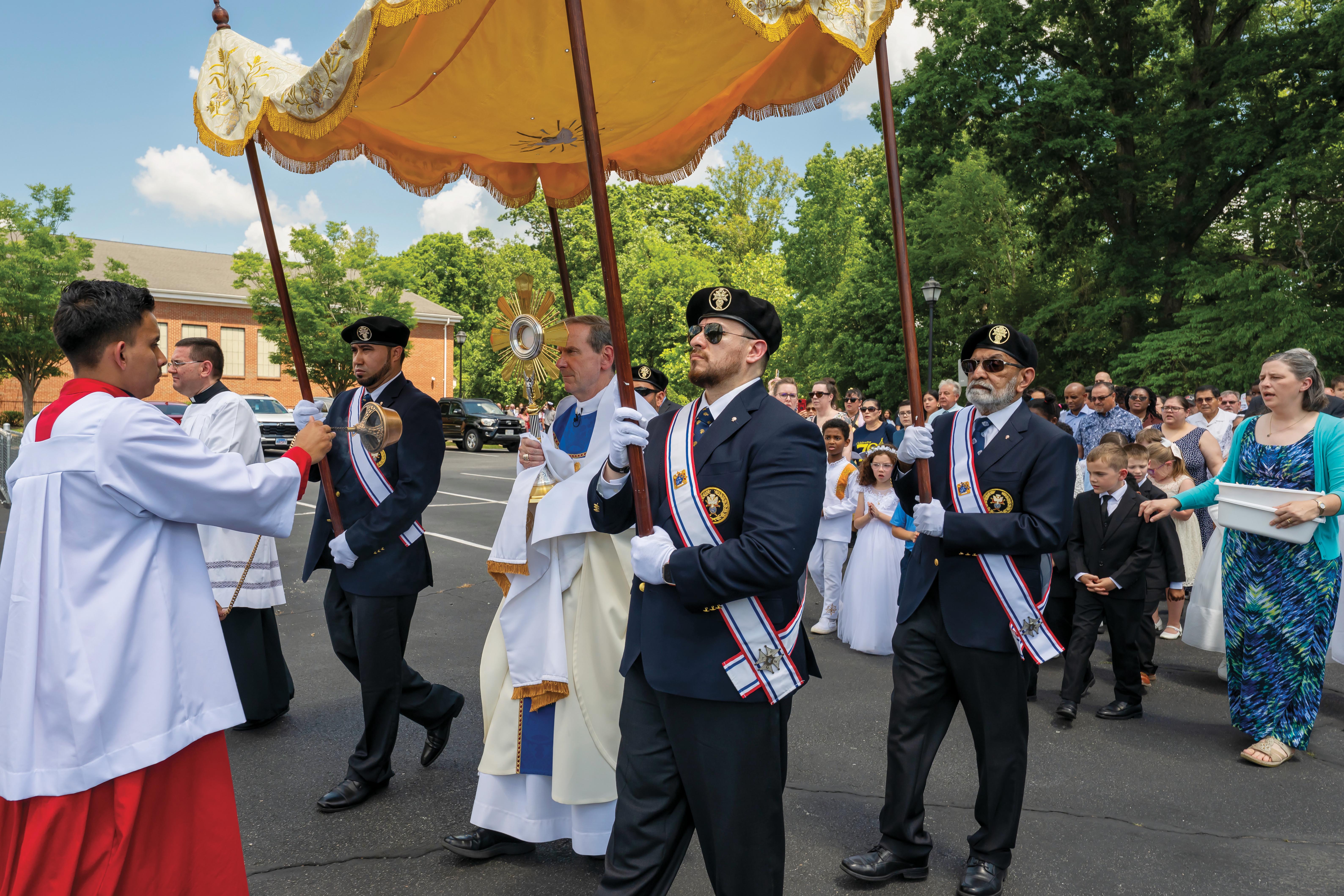 Bishop Michael F. Burbidge of Arlington leads a Corpus Christi procession in Stafford, Va.