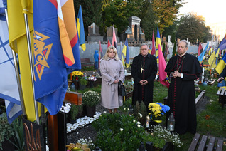 Supreme Chaplain Archbishop William Lori of Baltimore and Archbishop Mieczysław Mokrzycki of Lviv pray at the grave of a fallen soldier at Mars Field in Lviv.