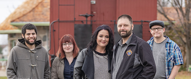 Family members pose for photo outside for Family of the Month.