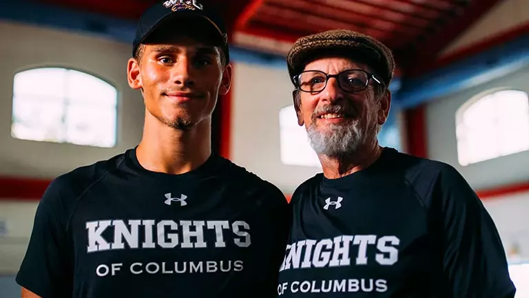 Father and Son Knights pausing for a photograph during disaster relief efforts.