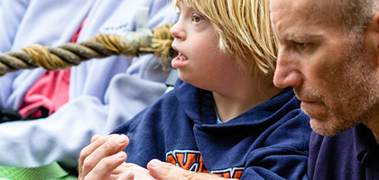 A father is attending Mass with a child who has special needs.