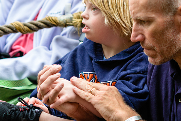 A father is attending Mass with a child who has special needs.