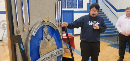 Father Marc Lim, pastor of Mary Our Queen Parish and School and chaplain of Mary Our Queen Council 11700 in  Omaha, Neb., blesses medals for winners of the council’s Free Throw Championship. 