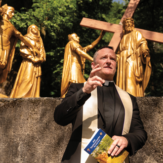 Jesuit Father Brian Reedy, a U.S. Navy lieutenant commander and chaplain, leads the Stations of the Cross at the Sanctuary of Our Lady of Lourdes in France .