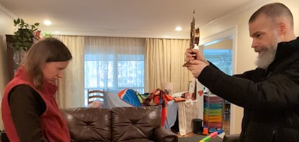 Father Charles Wilton, parochial vicar of St. Andrew the Apostle Church and chaplain of Father Julius J. Cilinski Council 10947 in Clifton, Va., blesses Gosia Paras, wife of family director Frederick Paras, with a first-class relic of Blessed Michael McGivney. 