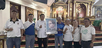 Knights from Banal na Sakramento Council 8753 in Quezon City, Luzon North, gather around an image of Blessed Michael McGivney following Mass at Banal na Sakramento Church to celebrate the conclusion of the council’s novena to Father McGivney.