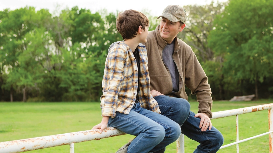 A father and son share a conversation.