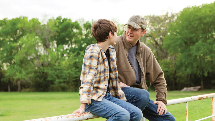A father and son share a conversation.