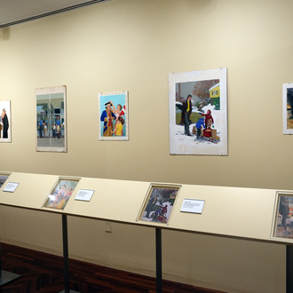 Photo of a museum exhibit interior featuring five magazine cover art paintings.