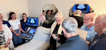 Bishop Frank Dewane of Venice blesses a new ultrasound machine purchased by Ponce de Leon Council 8074 in Punta Gorda, Fla., for Pregnancy Solutions’ North Port facility. The council raised more than $20,000 through a baby bottle drive and donations, including a $7,000 contribution from 4US-Adopt-a-Center.