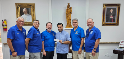 Knights from St. John Neumann Council 5971 in Plantation, Fla., present a $2,600 check to Father Yamil Miranda, pastor of All Saints Catholic Church and a brother Knight, to commission a monument to the unborn for the parish. Council 5971’s donation came at the request of the parish and will cover the total cost.