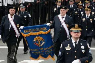 Faithful Pilot Joseph Ozog (right) of Christopher Columbus Assembly 2349 in Harwood Heights, Ill., and Steve Meinecke of Bishop Raymond P. Hillinger Assembly 1595 in Niles carry a K of C banner during the 93rd annual St. Jude Police Memorial March in downtown Chicago. Thousands attended to honor first responders killed in the line of duty.