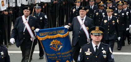 Faithful Pilot Joseph Ozog (right) of Christopher Columbus Assembly 2349 in Harwood Heights, Ill., and Steve Meinecke of Bishop Raymond P. Hillinger Assembly 1595 in Niles carry a K of C banner during the 93rd annual St. Jude Police Memorial March in downtown Chicago. Thousands attended to honor first responders killed in the line of duty.