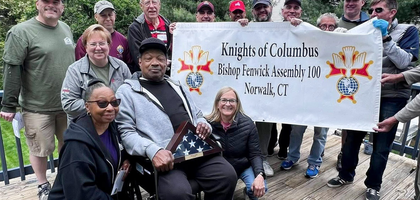 Knights from Bishop Fenwick Assembly 100 in Norwalk, Conn., stand with House of Heroes staff and Willie Jones, a U.S. Army veteran, after helping to repair and paint a deck, clean a basement, and install a handrail at Jones’ home. 