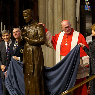 Cardinal Timothy Dolan, archbishop of New York, Supreme Knight Patrick Kelly (third from left), and relatives of Blessed Michael McGivney.