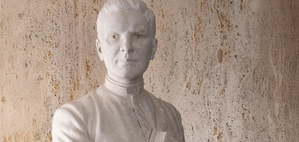 A head and shoulder picture of a all white Father McGivney Statue.