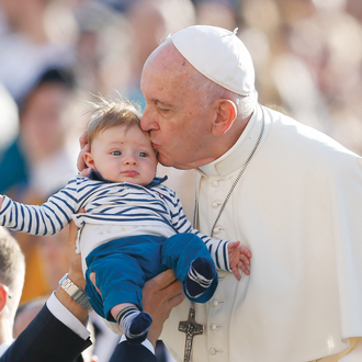 Pope Francis kisses a child during his general audience on Oct. 23, 2019