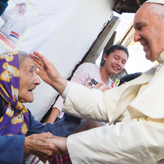 Pope Francis greets a woman during his visit to Asunción, Paraguay, July 12, 2015