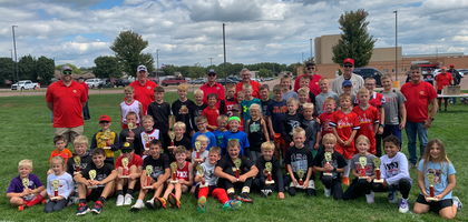Members of Split Rock Council 13400 in Brandon, S.D., gather with participants of the council’s “Punt, Pass, and Kick” football competition at Brandon Valley High School. The event coincided with the school’s Pig Skin Classic, a community celebration for the first home football game. Nearly 60 boys and girls ages 7-12 participated. The council awarded trophies to the first-, second- and third-place winners for each age group. 