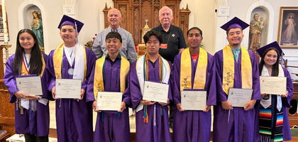 Deputy Grand Knight Larry Turner (right) and Financial Secretary Jack Planchard of Good Samaritan Council 14181 in Ellijay, Ga., pose with seven Gilmer High School graduates after awarding each a $1,000 scholarship. 