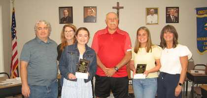 Grand Knight Mike Abbate (center) of Ascension of our Lord Council 9623 in La Place, La., presents Catholic Youth Leadership Awards to high school seniors Caylee Drexel (left) and Katherine Chapman.
