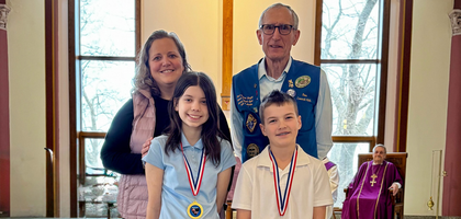 Past Grand Knight Dave Tlachac of Msgr. Basche Council 4505 in Green Bay, Wis., and Principal Kari Peterson of Holy Cross Catholic School stand with winners of the council’s annual pro-life essay contest, themed “Whatever you did for one of the least brothers of mine, you did for me” (Mt 25:35-40).
